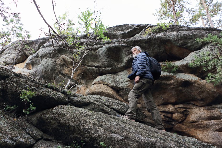 A man hiking along a rocky outdoor trail